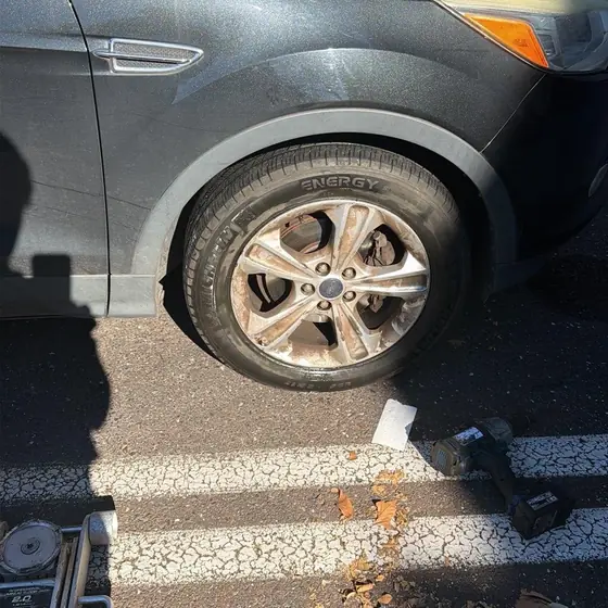 The same Ford with a new Michelin tire on, impact wrench on the ground beside it