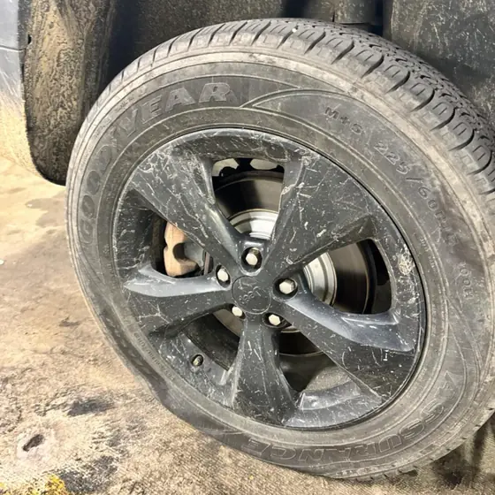 Flat Goodyear tire on a Jeep in a parking garage