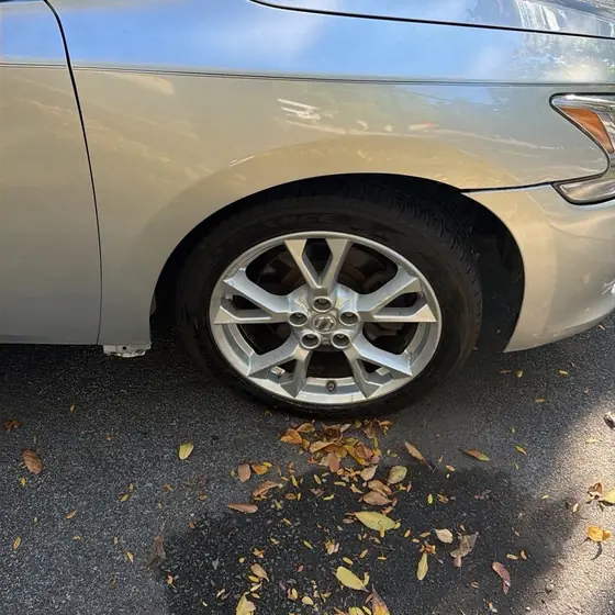The same Nissan with the front wheel back on